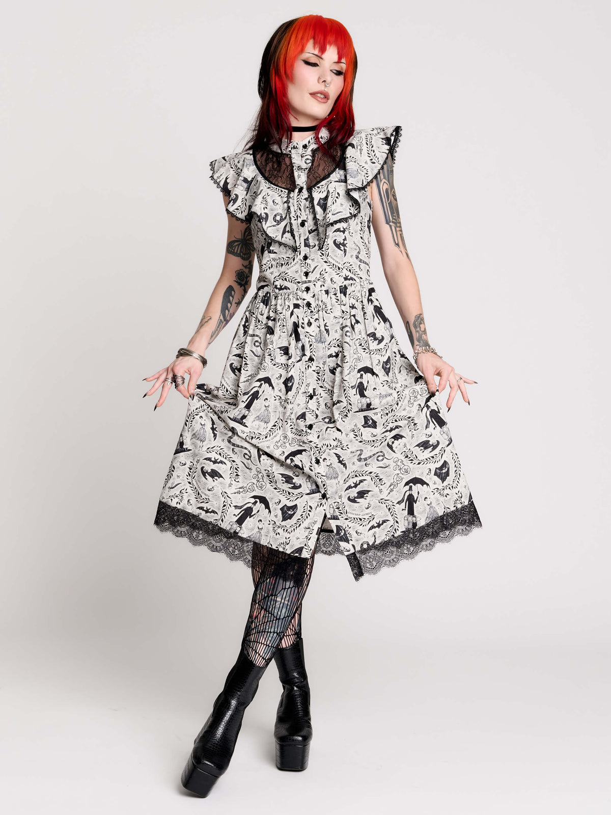 black and white gothic-style dress with a bird pattern, lace trim, and a high ruffled collar