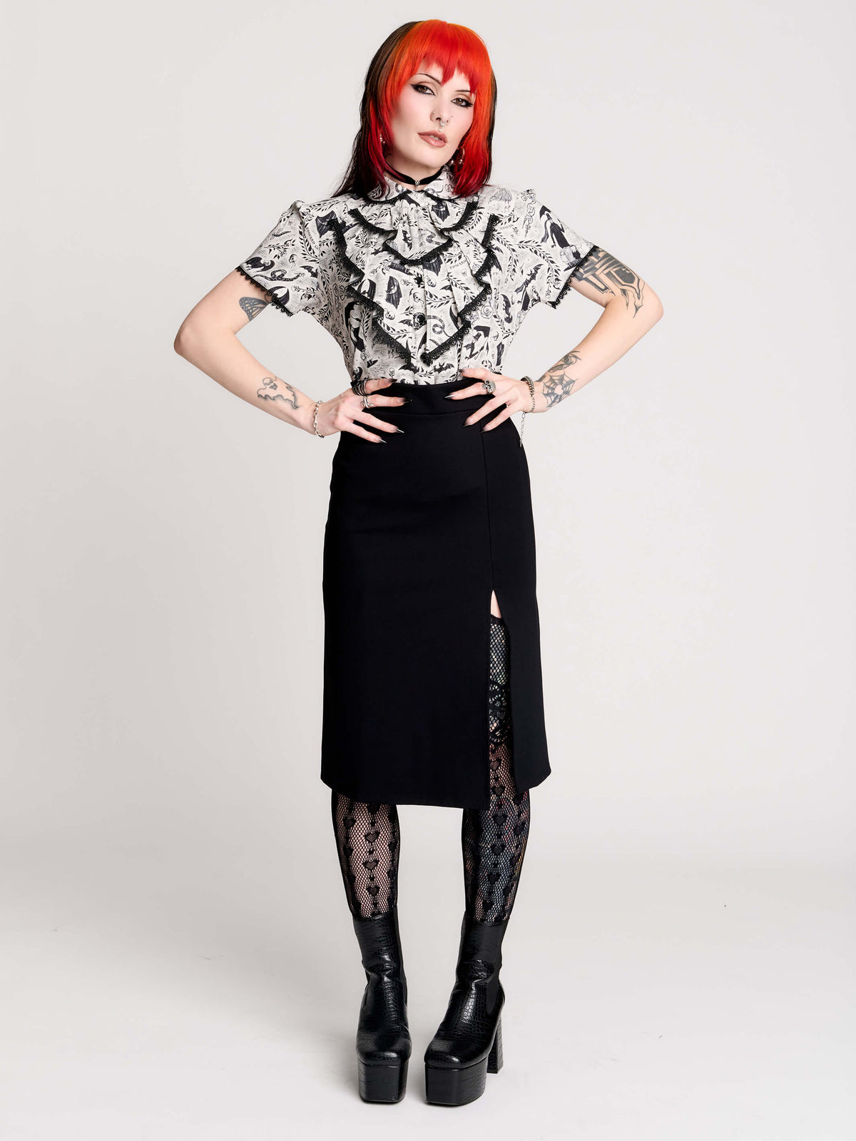 a black and white patterned ruffled blouse