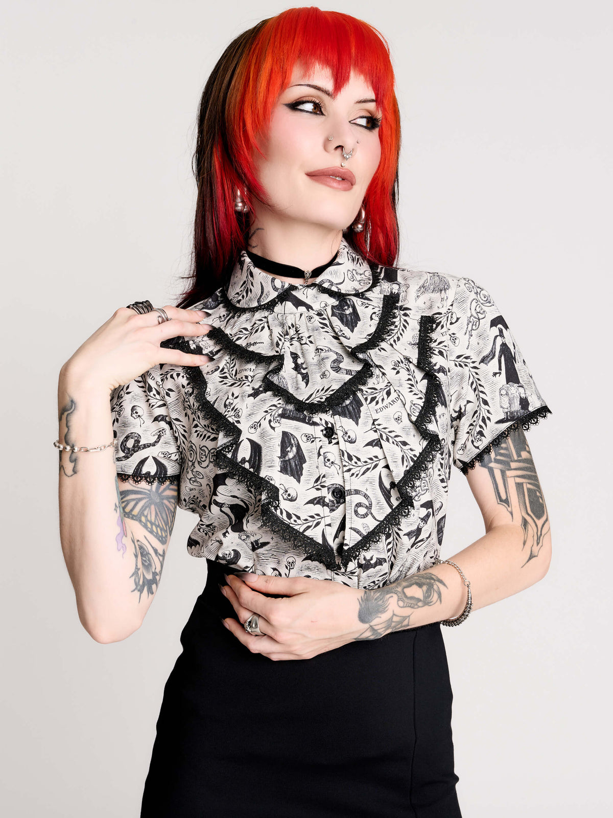 a black and white patterned ruffled blouse