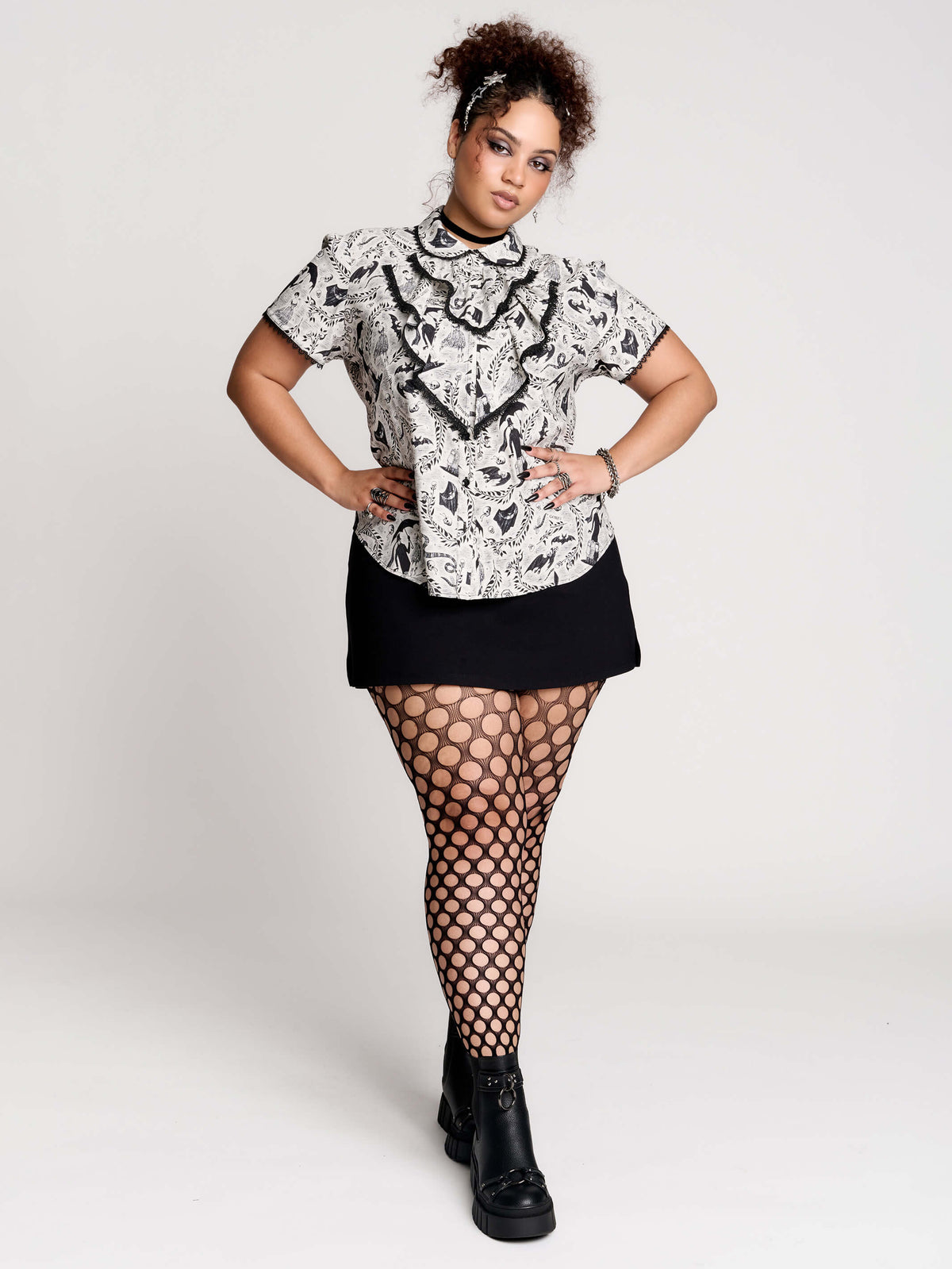 a black and white patterned ruffled blouse