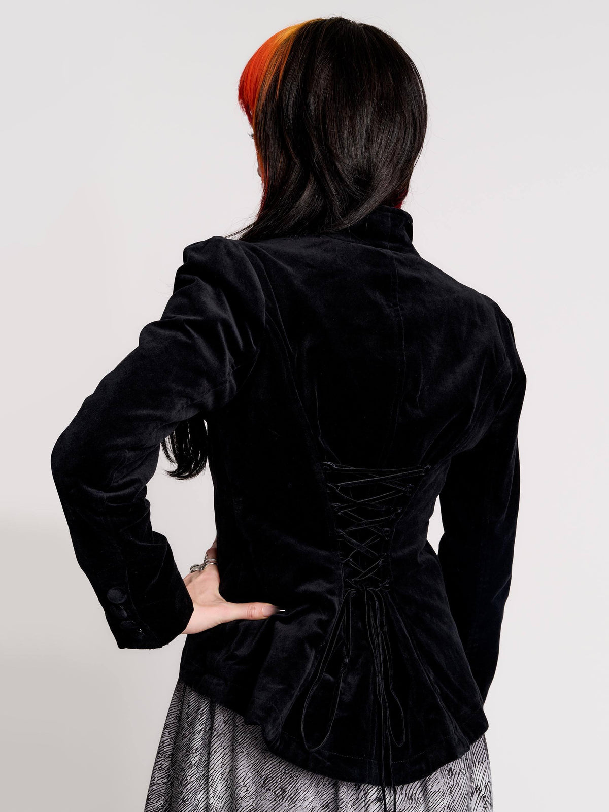 black velvet jacket with a black-and-white patterned lining and back lace up detail