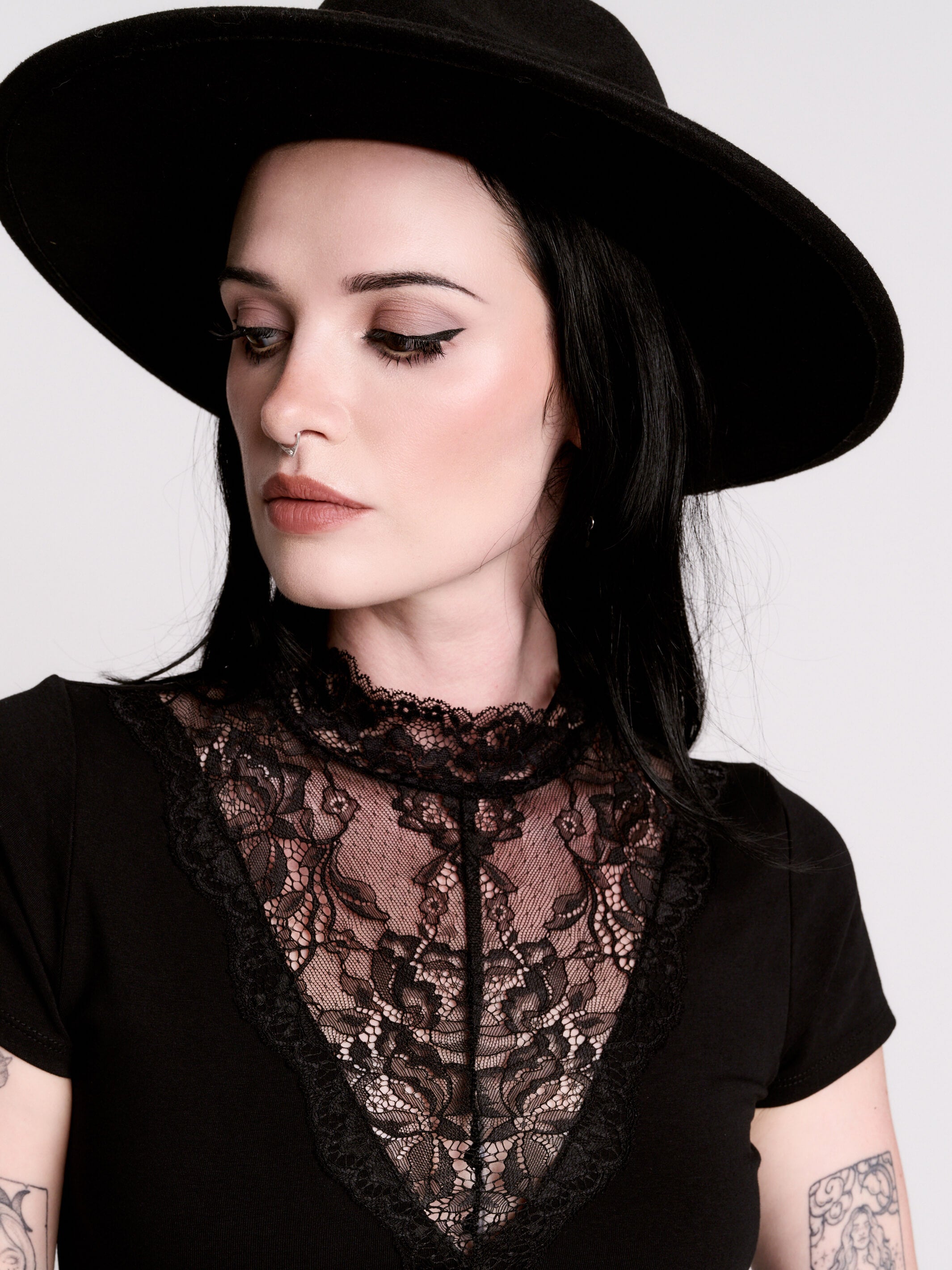 A black short-sleeve dress with a lace V-neckline.