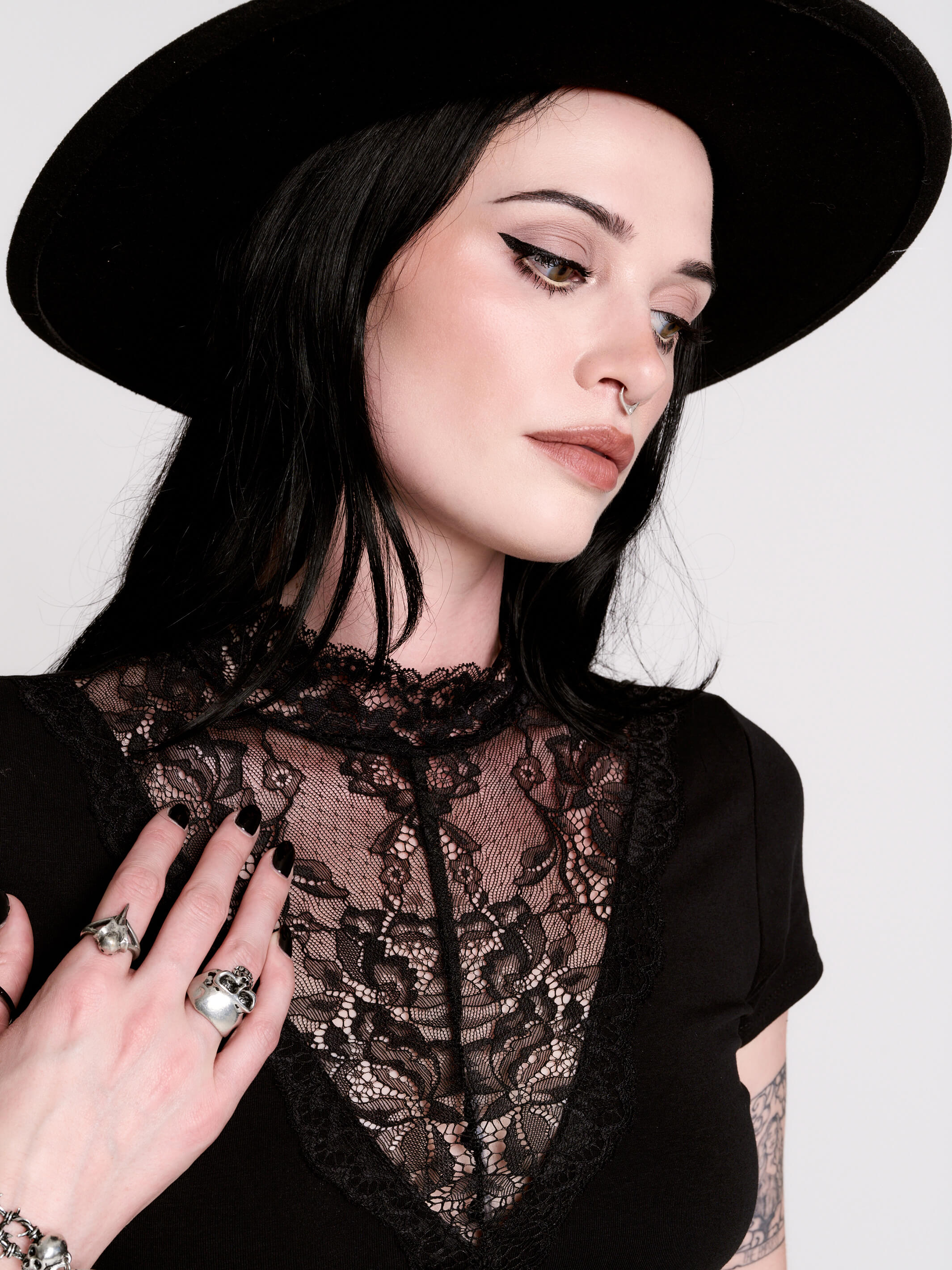 A black short-sleeve dress with a lace V-neckline.