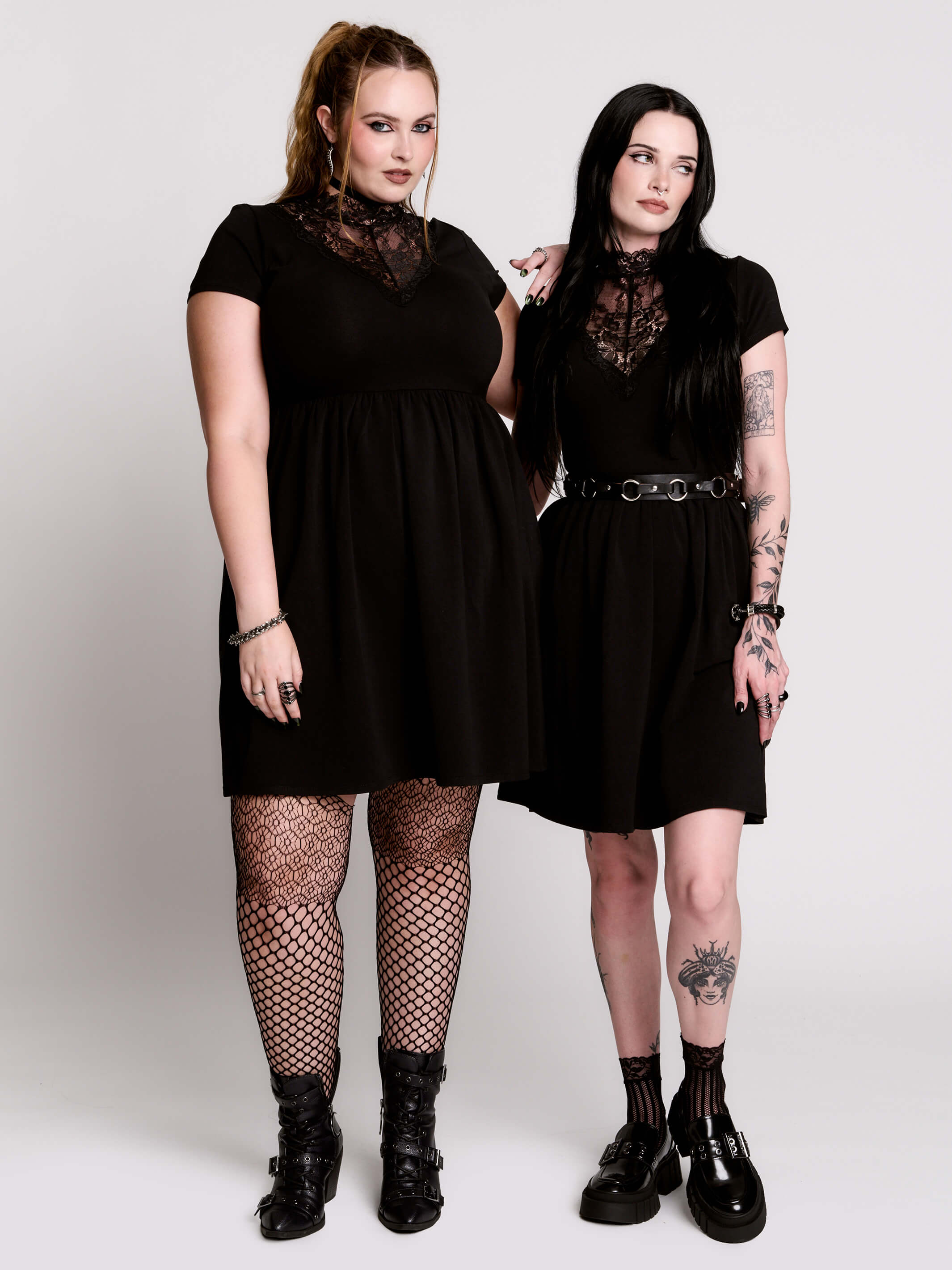 A black short-sleeve dress with a lace V-neckline.