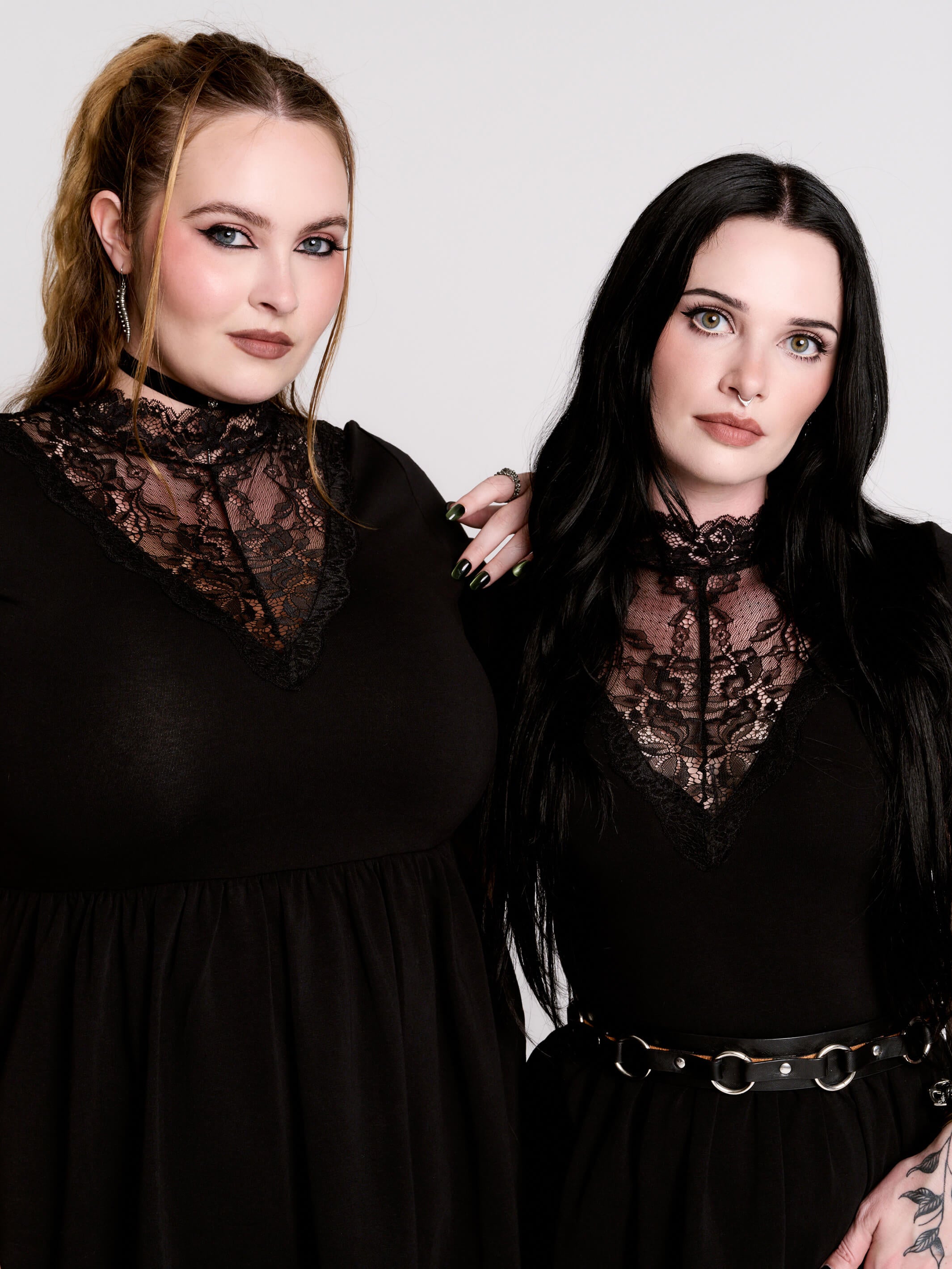 A black short-sleeve dress with a lace V-neckline.