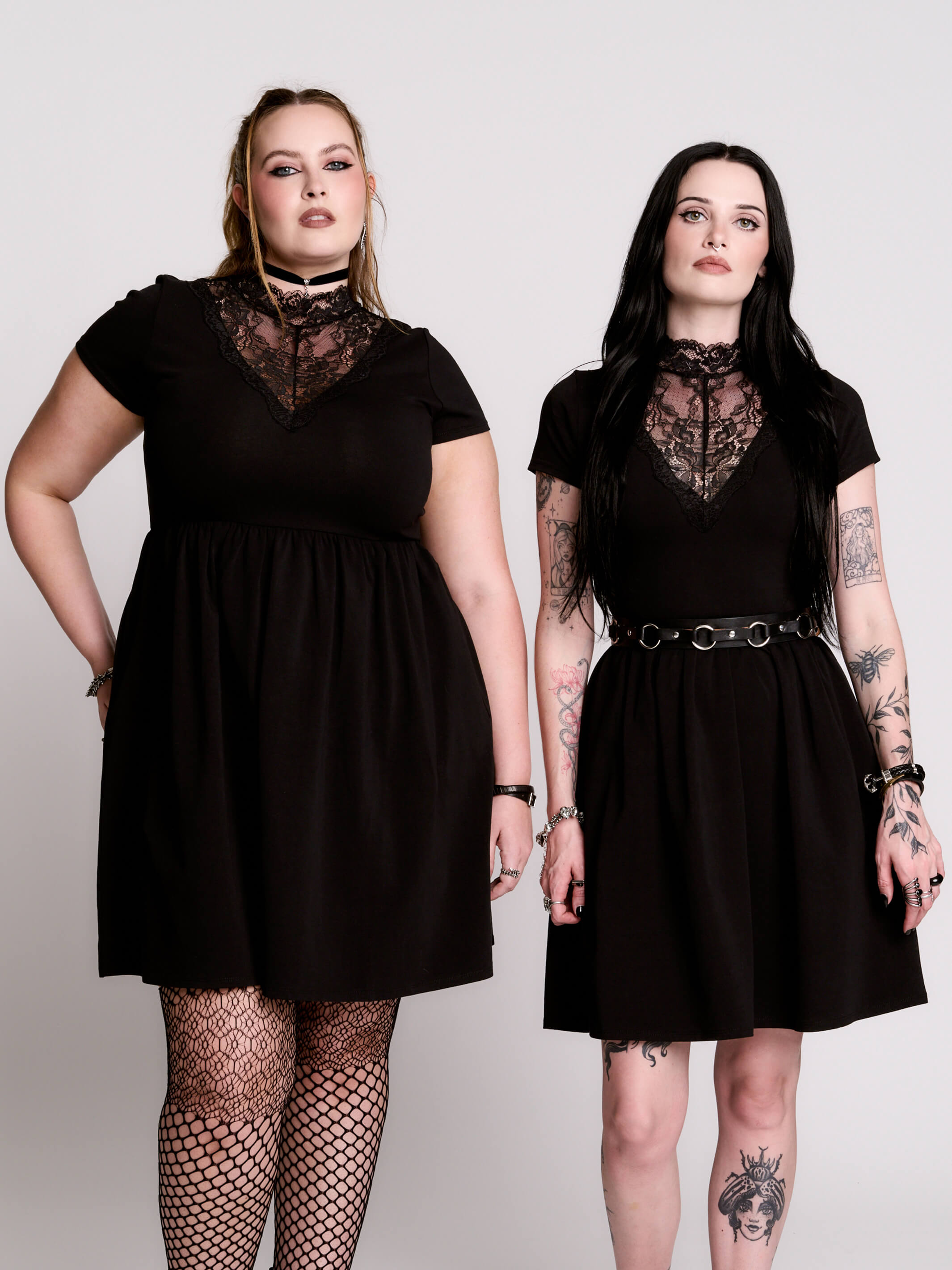 A black short-sleeve dress with a lace V-neckline.