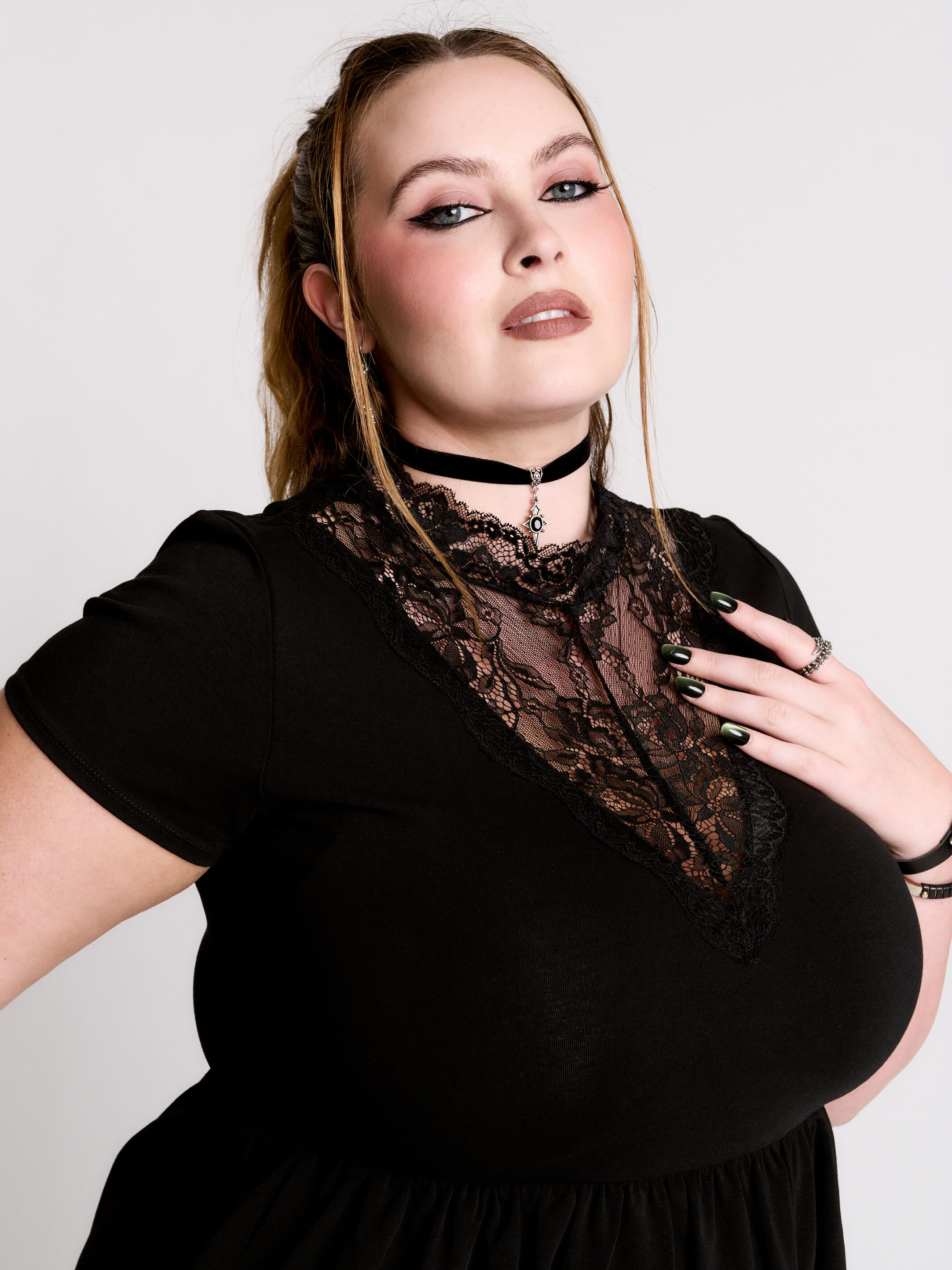 A black short-sleeve dress with a lace V-neckline.