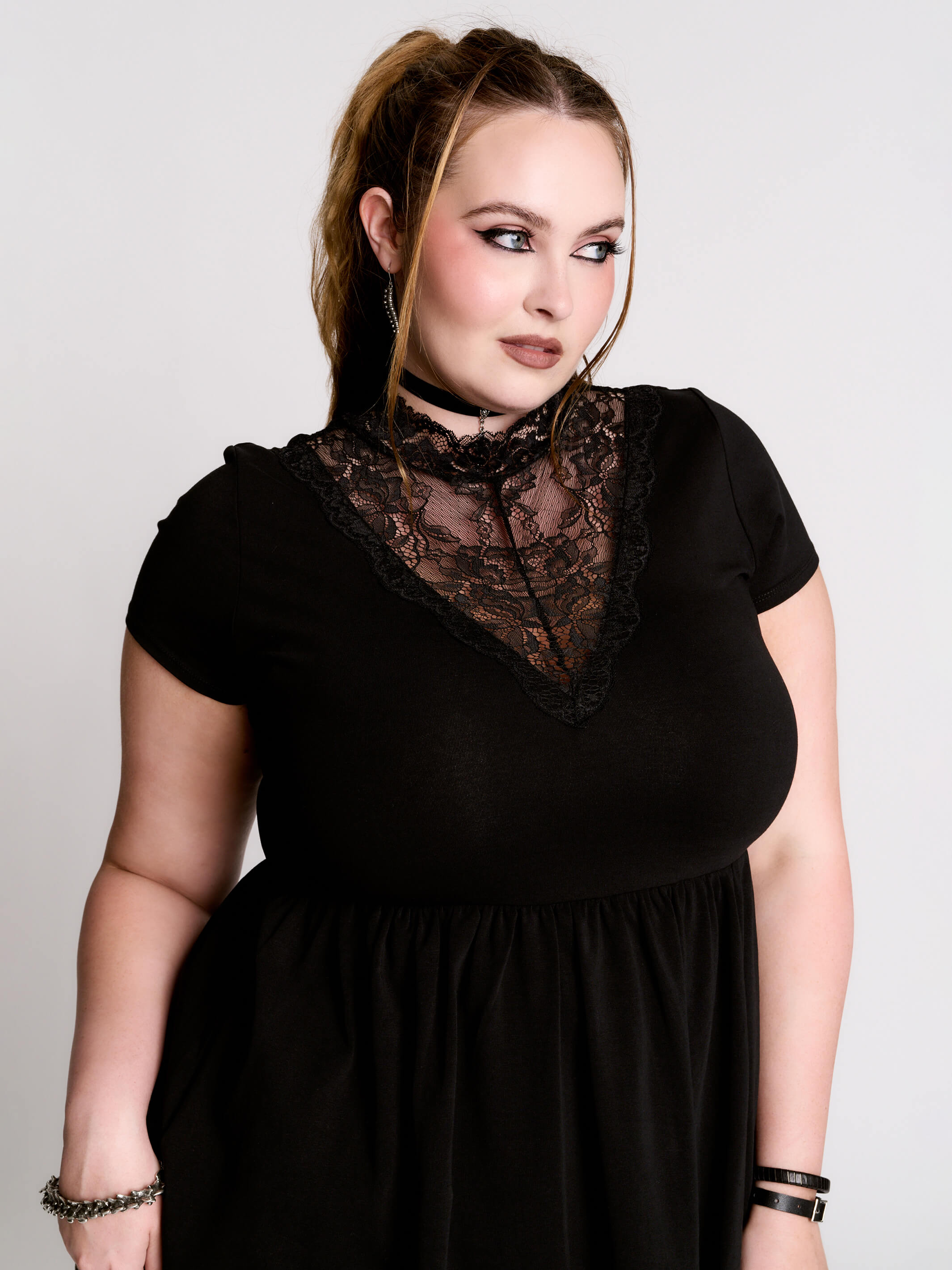 A black short-sleeve dress with a lace V-neckline.