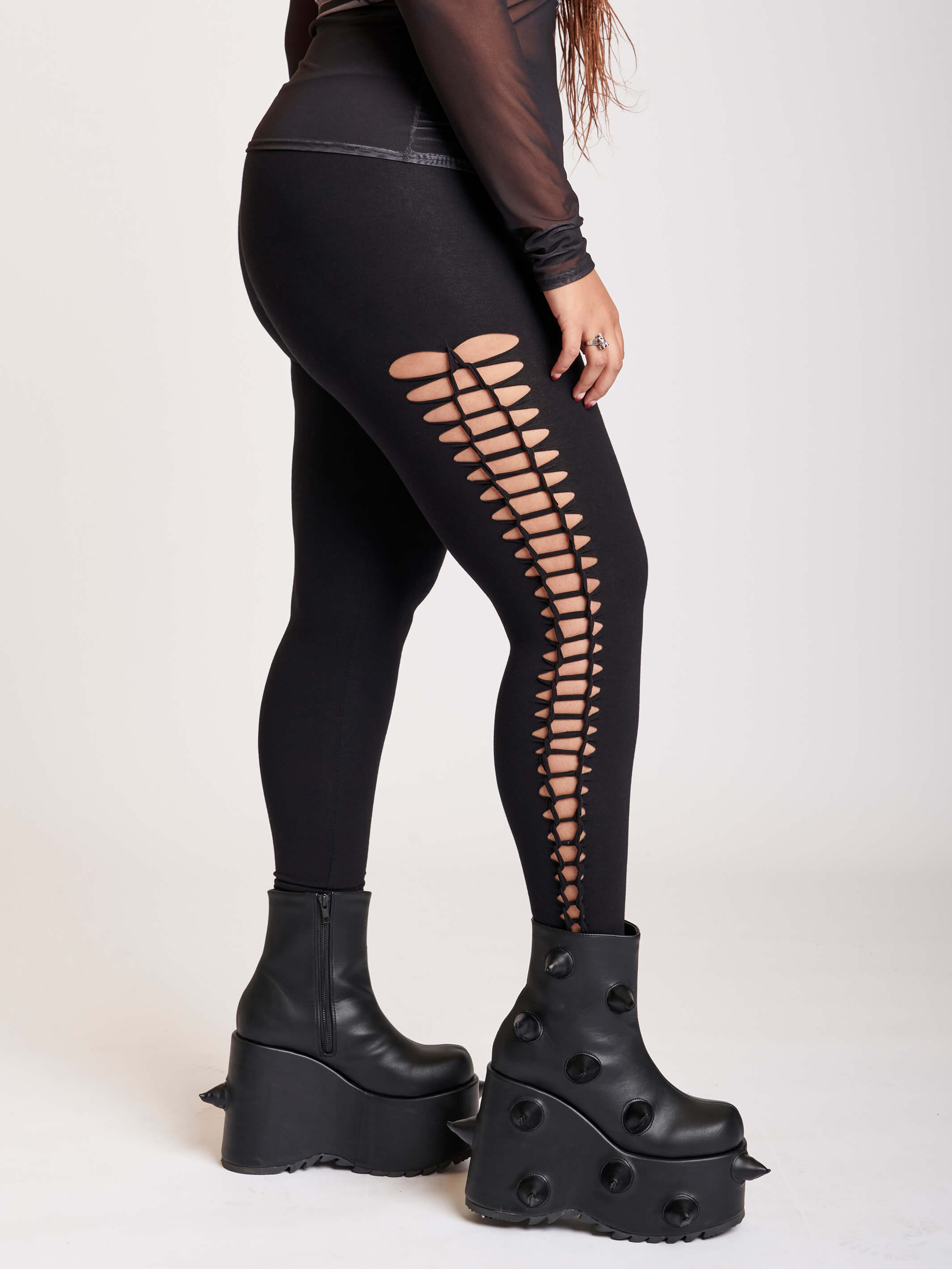 Stretchy cotton spandex leggings with slashed and braided side details.
