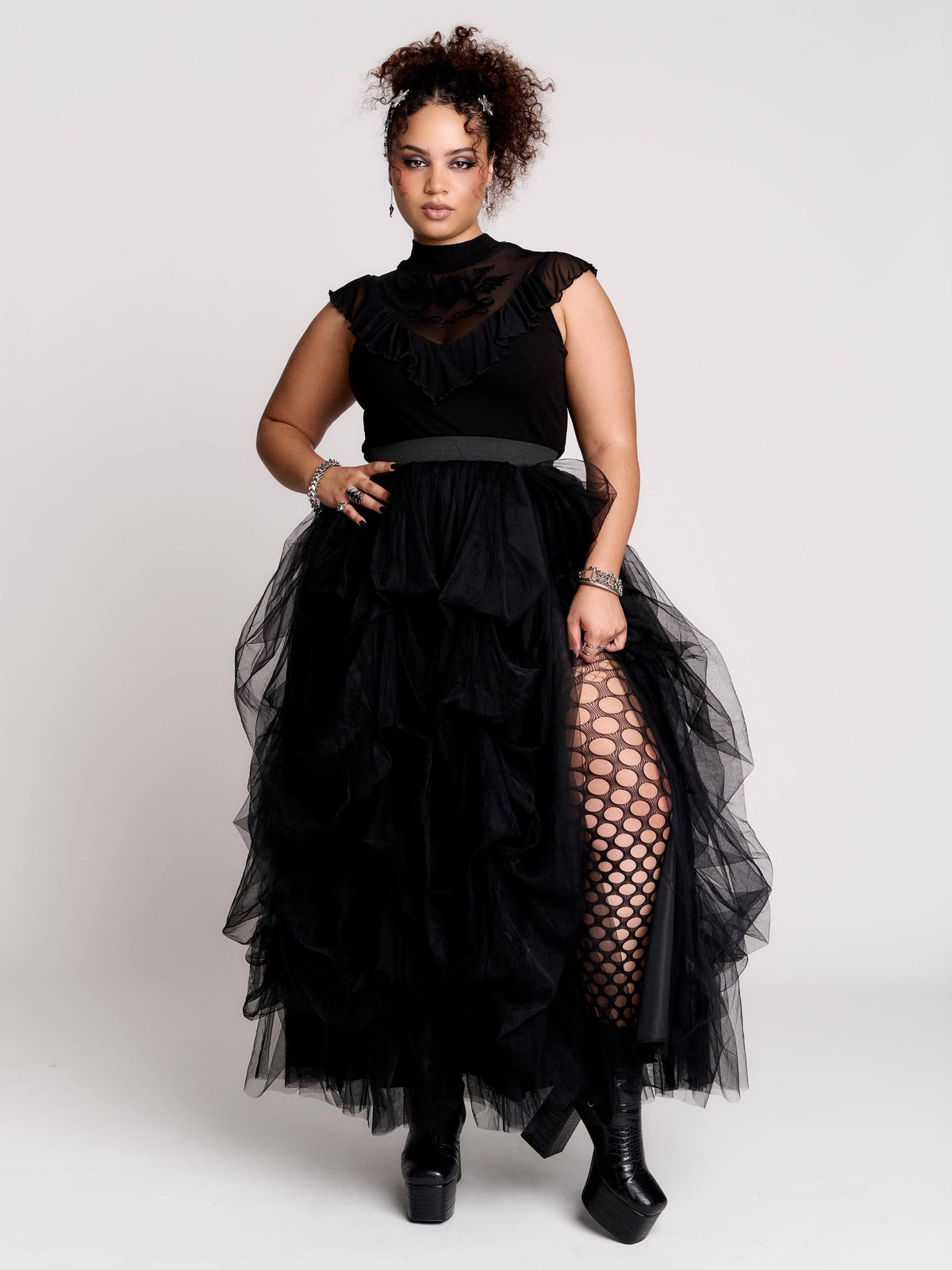a voluminous layered black tulle skirt.