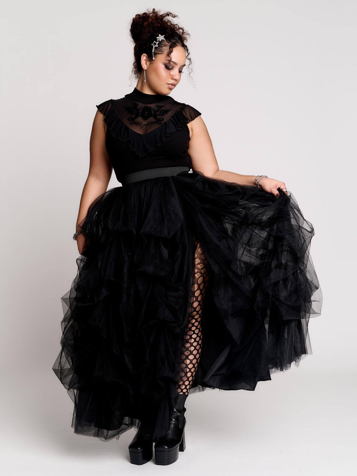 a voluminous layered black tulle skirt.