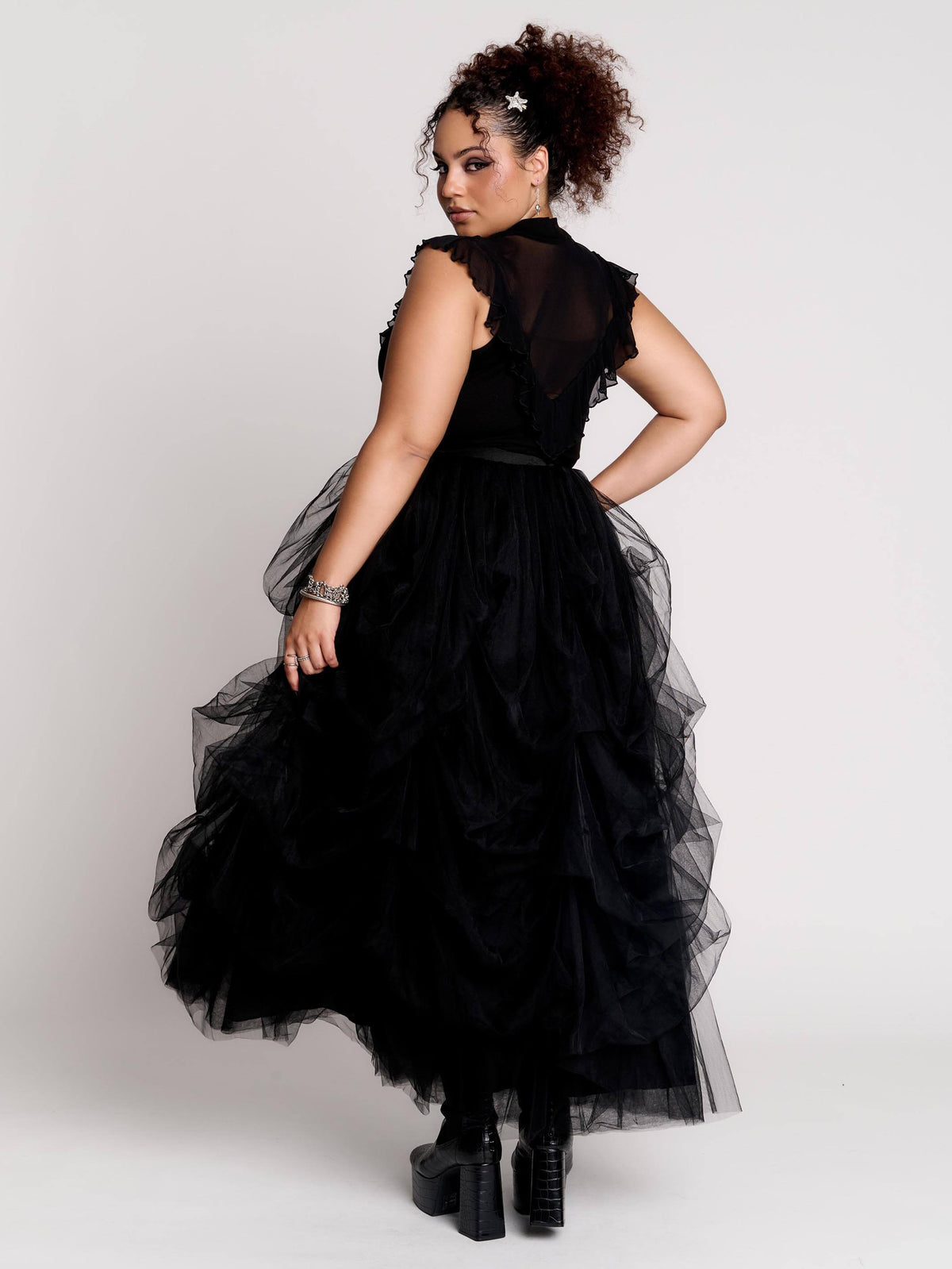 a voluminous layered black tulle skirt.
