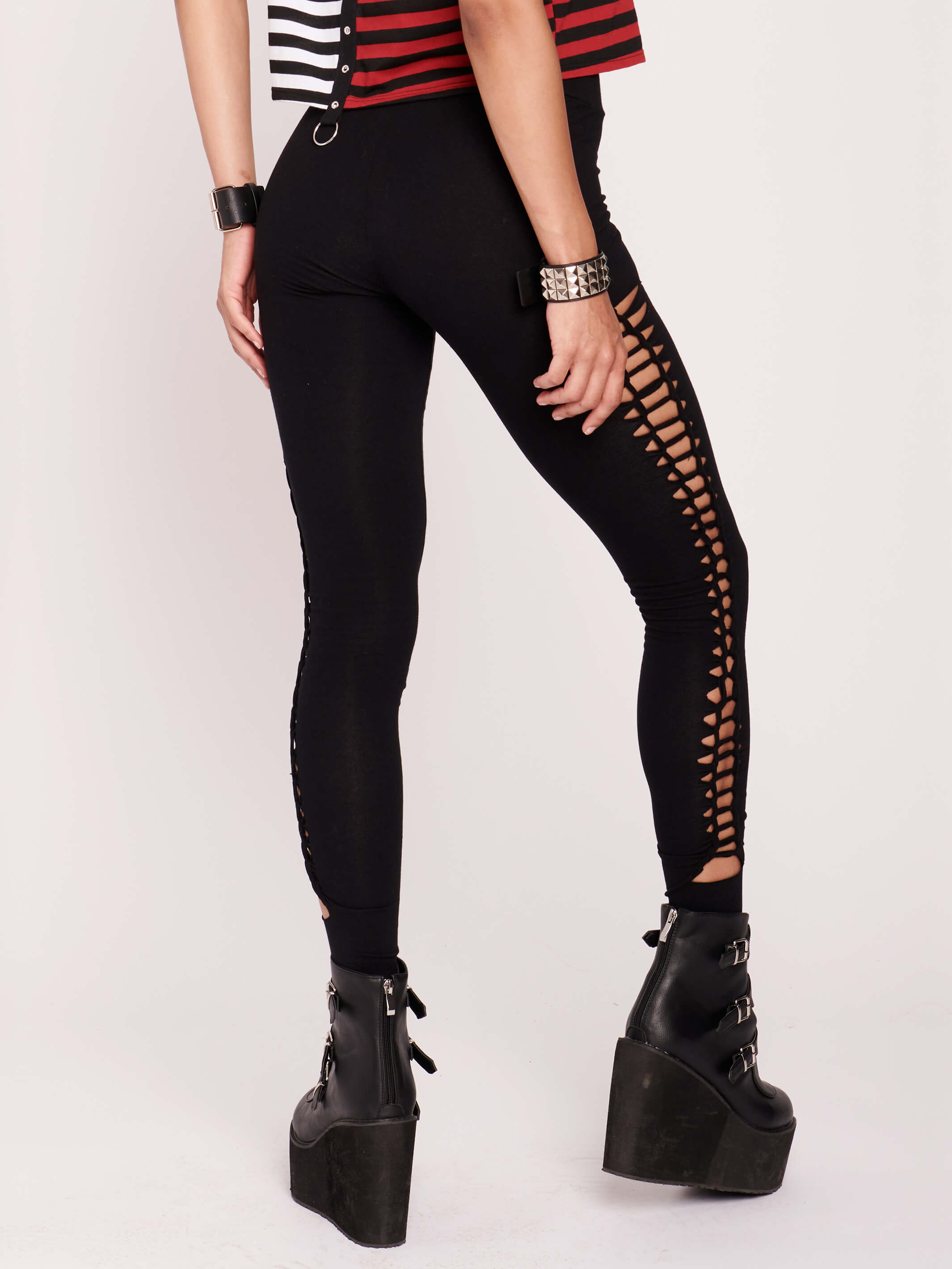 Stretchy cotton spandex leggings with slashed and braided side details.
