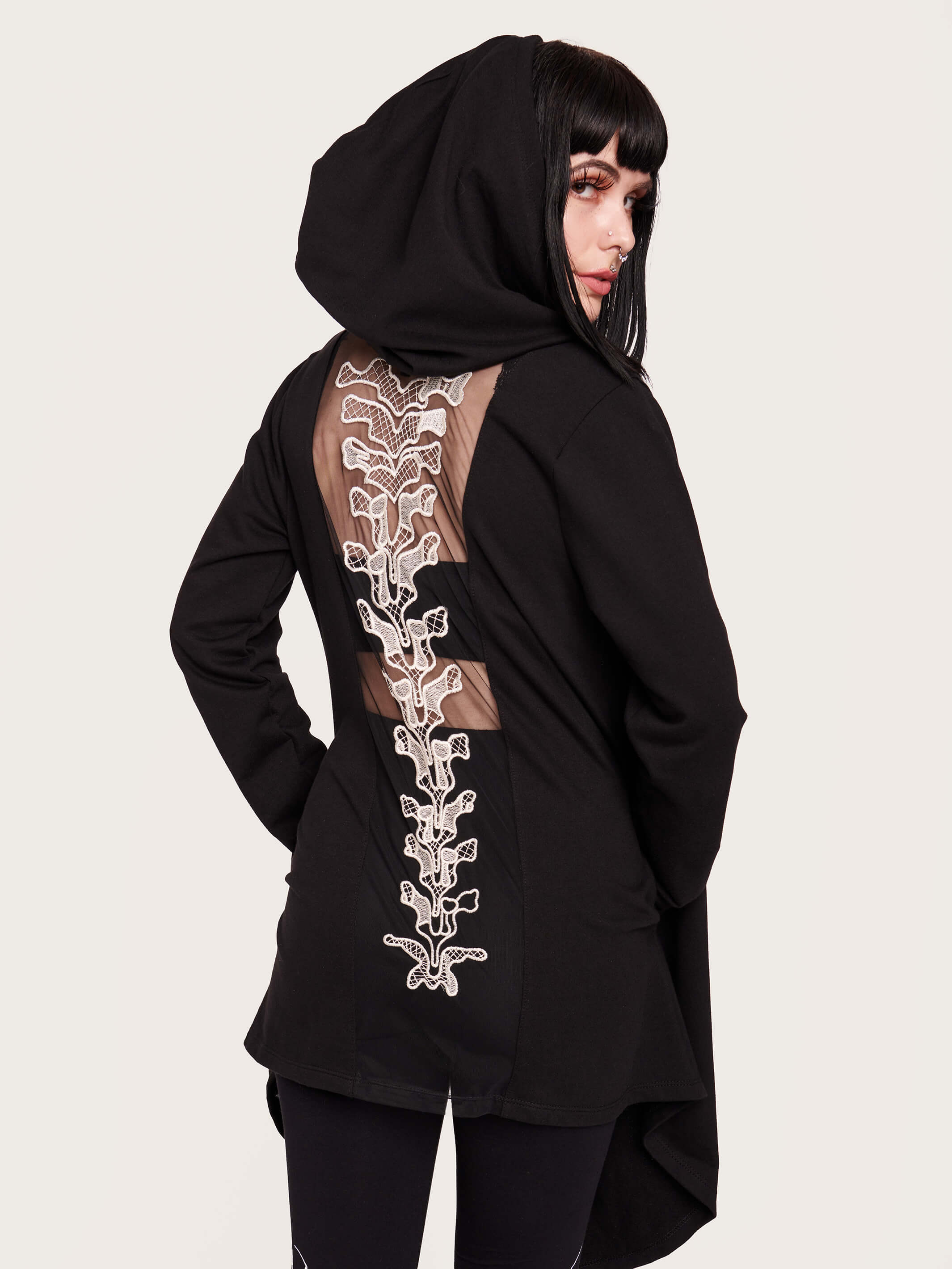 Tap into some voodoo vibes with this embroidered spinal back detail on our french terry hooded cloak. Crescent moon & rose embroidery on the front. Assymetrical hem with pockets. Goth grunge fashion, alt girl fashion, goth clothing, summer goth, skull top, goth punk top, egirl fashion, emo fashion.
