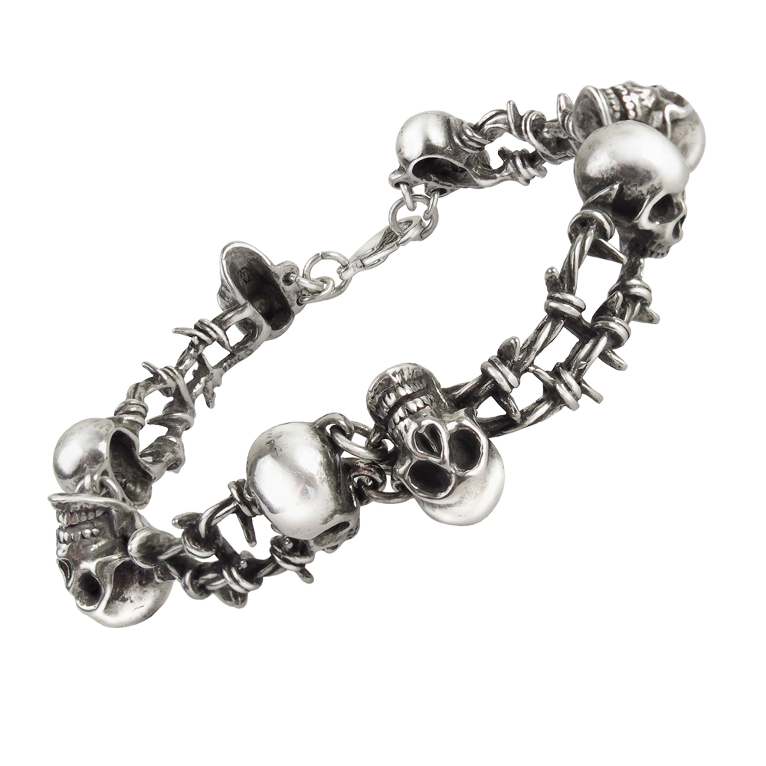 Silver bracelet with skull and barbed wire designs.