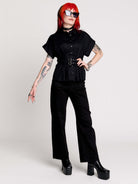 a black short-sleeve button-front shirt dress with a matching double-buckle front waist details.