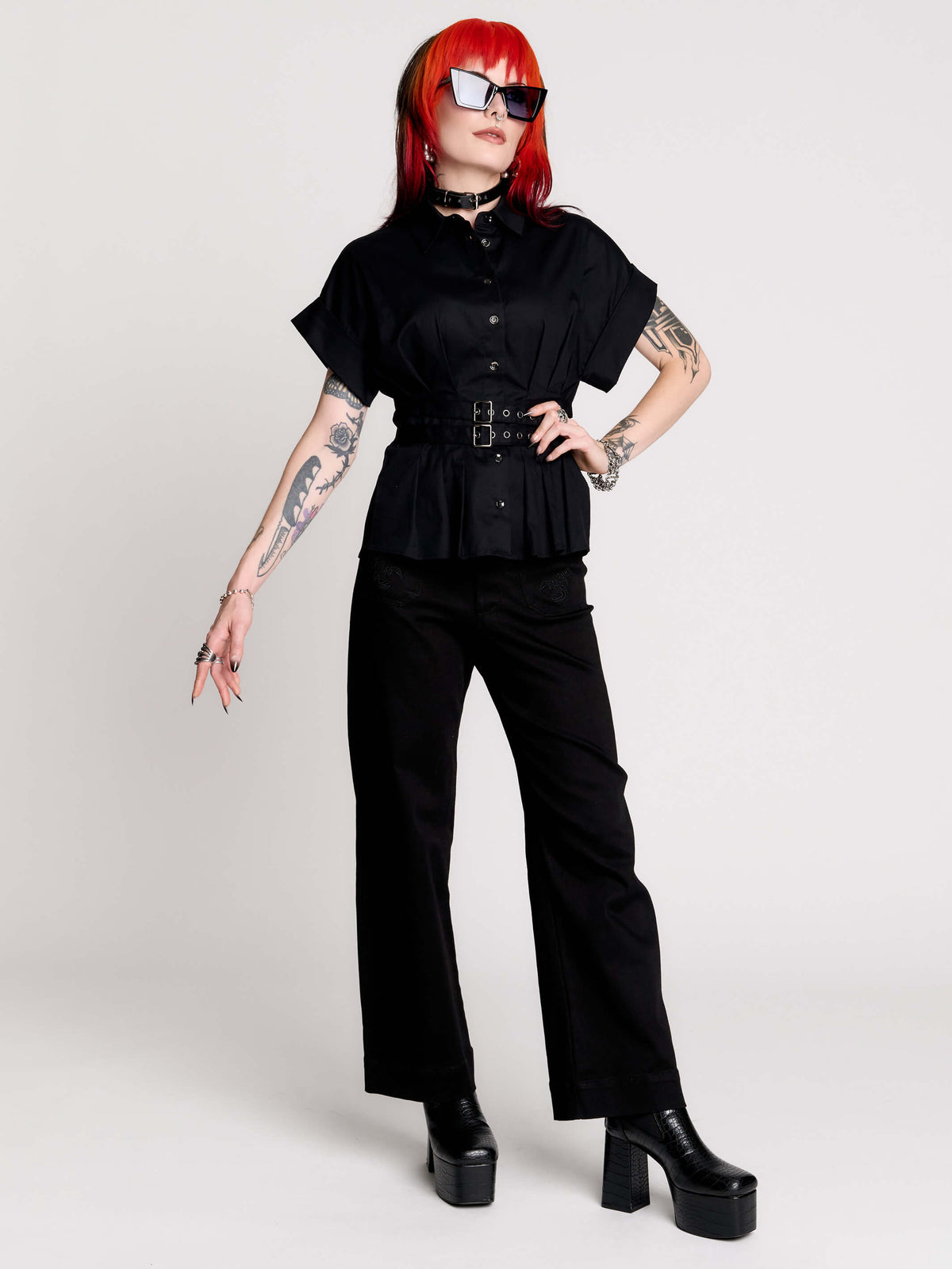 a black short-sleeve button-front shirt dress with a matching double-buckle front waist details.