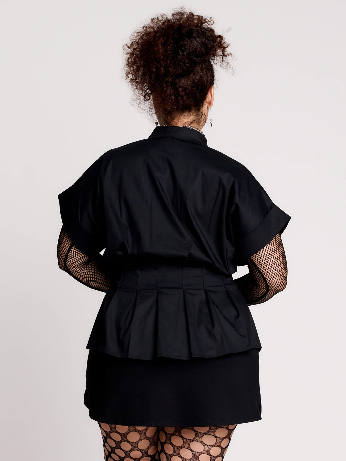 a black short-sleeve button-front shirt dress with a matching double-buckle front waist details.