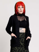 a black knit cardigan with braided details