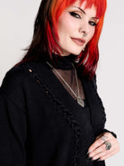 a black knit cardigan with braided details