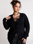 a black knit cardigan with braided details