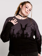  cemetery silhouette and a winged angel statue—spans the chest and sleeves, with a moody light charcoal ombré fade into deep black. 