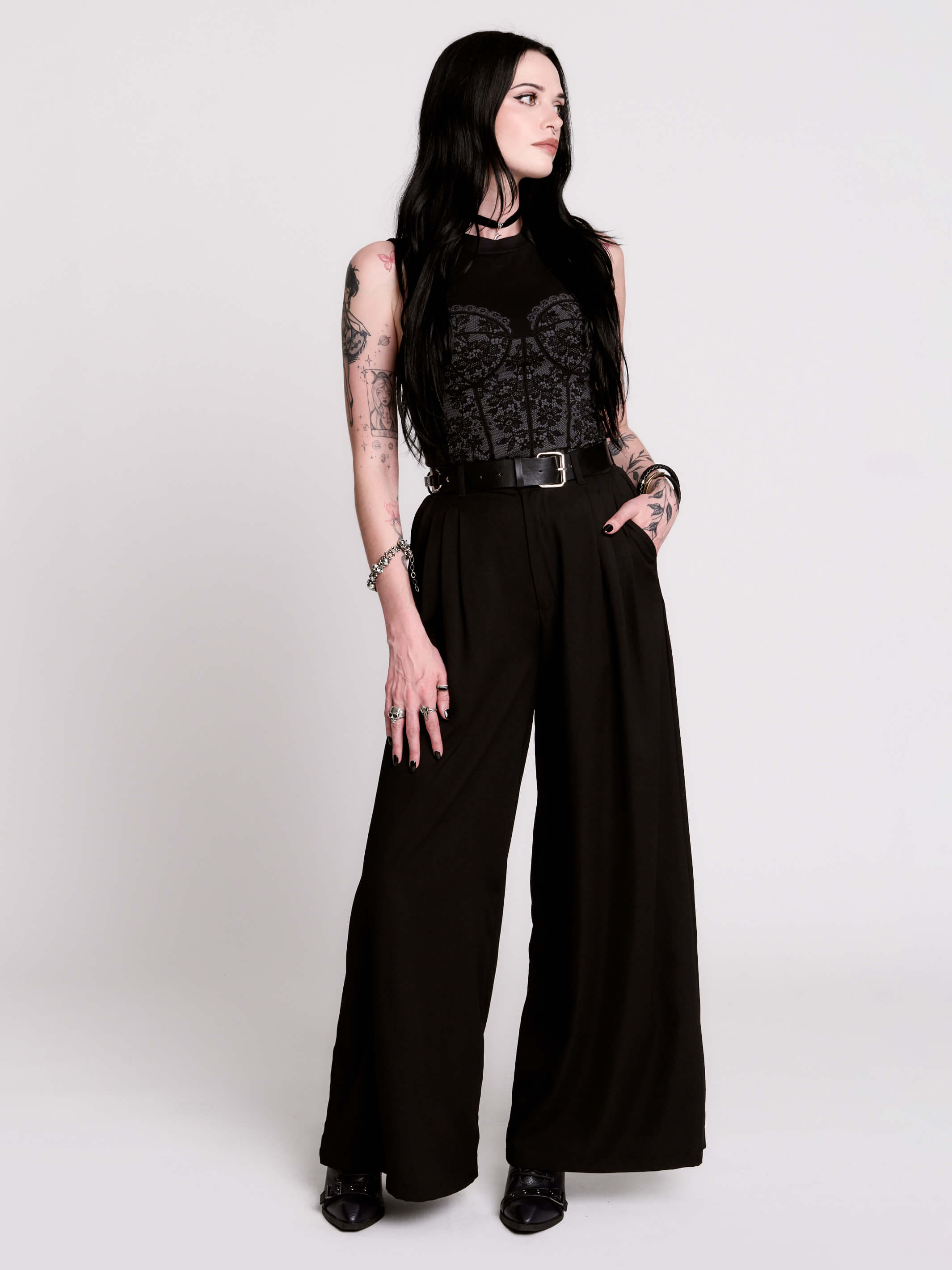 A black sleeveless top with a printed floral lace corset in light grey.