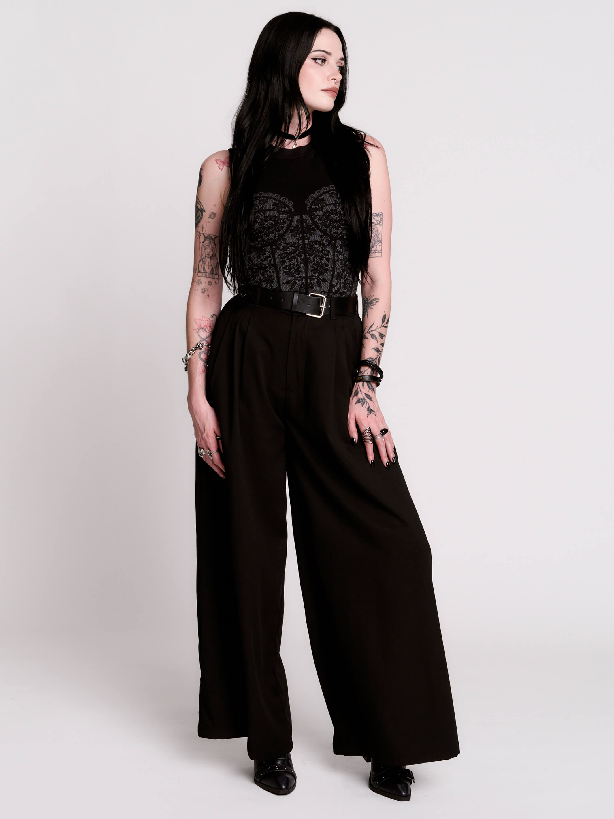 A black sleeveless top with a printed floral lace corset in light grey.