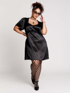 black satin short-sleeve dress with lace trim