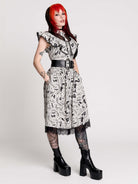 black and white gothic-style dress with a bird pattern, lace trim, and a high ruffled collar