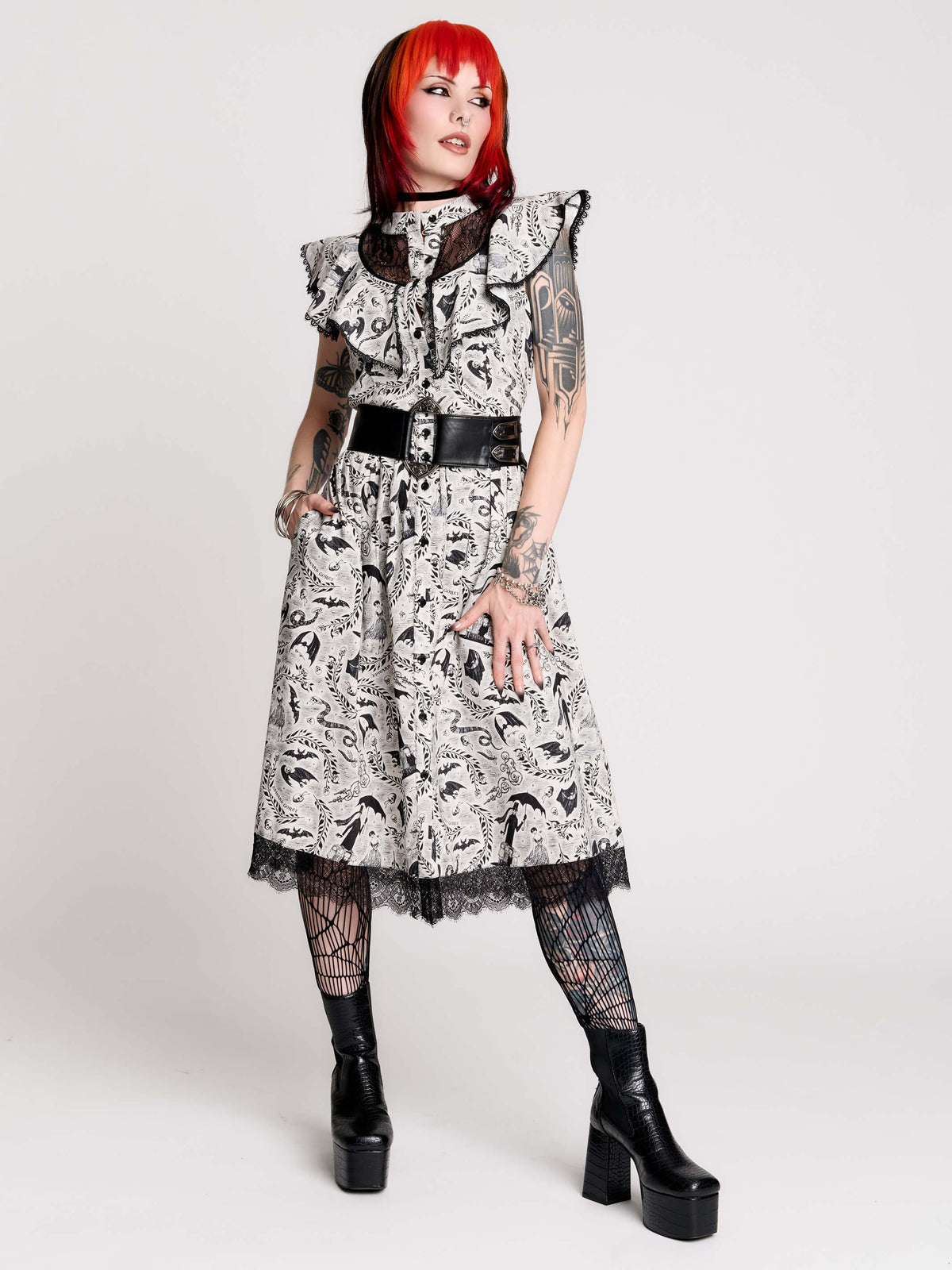 black and white gothic-style dress with a bird pattern, lace trim, and a high ruffled collar