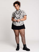  a black and white patterned ruffled blouse