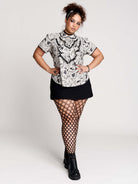  a black and white patterned ruffled blouse