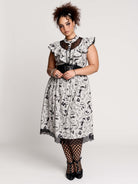 black and white gothic-style dress with a bird pattern, lace trim, and a high ruffled collar