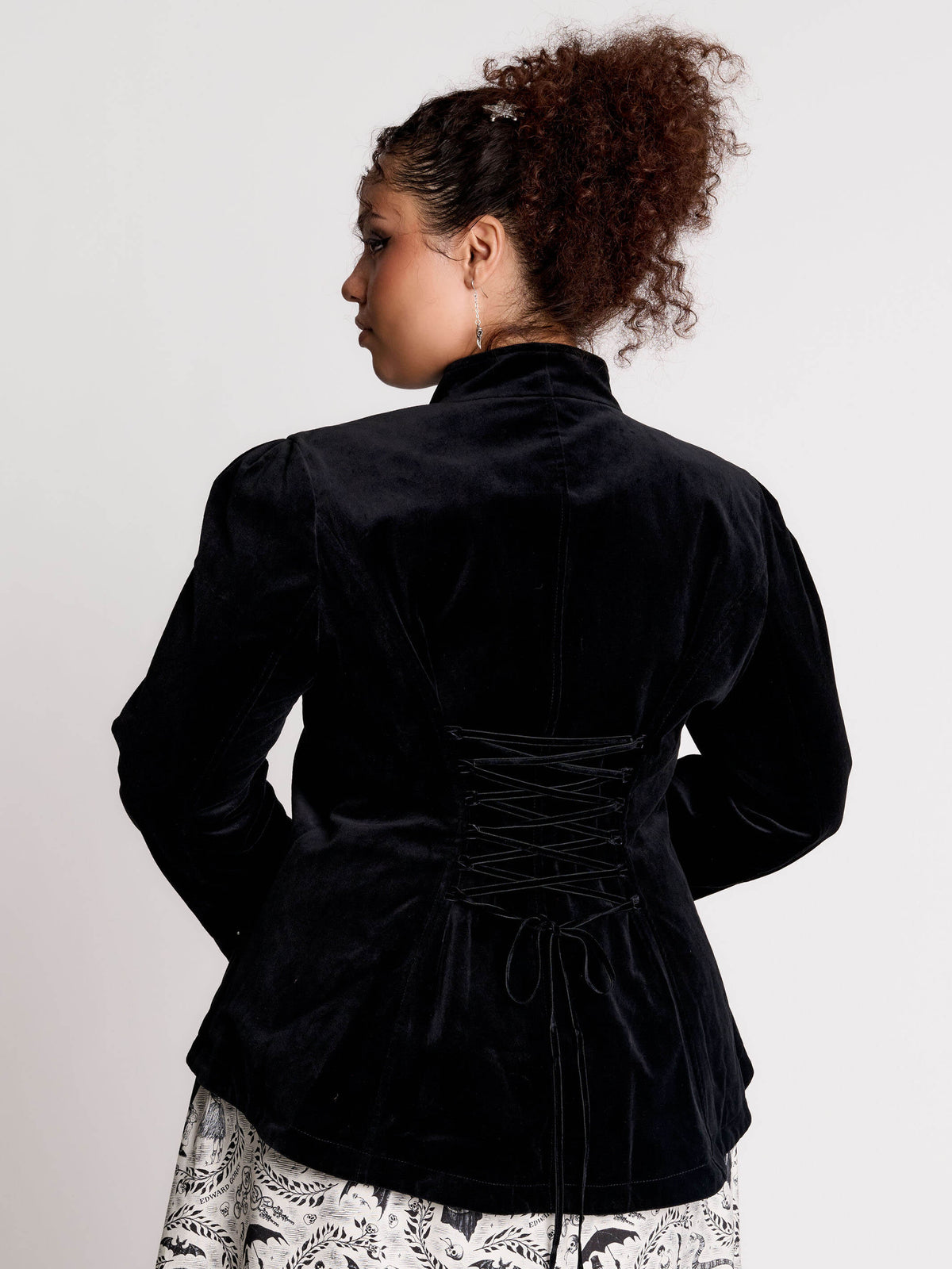 black velvet jacket with a black-and-white patterned lining and back lace up detail