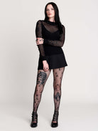Fishnet Sweetheart Rib Sweater, a black long-sleeve top with a fitted rib-knit body and fishnet across the upper chest, shoulders, upper back and sleeves, giving a  “sweetheart” illusion while keeping the sleek silhouette sleek.