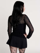 Fishnet Sweetheart Rib Sweater, a black long-sleeve top with a fitted rib-knit body and fishnet across the upper chest, shoulders, upper back and sleeves, giving a  “sweetheart” illusion while keeping the sleek silhouette sleek.