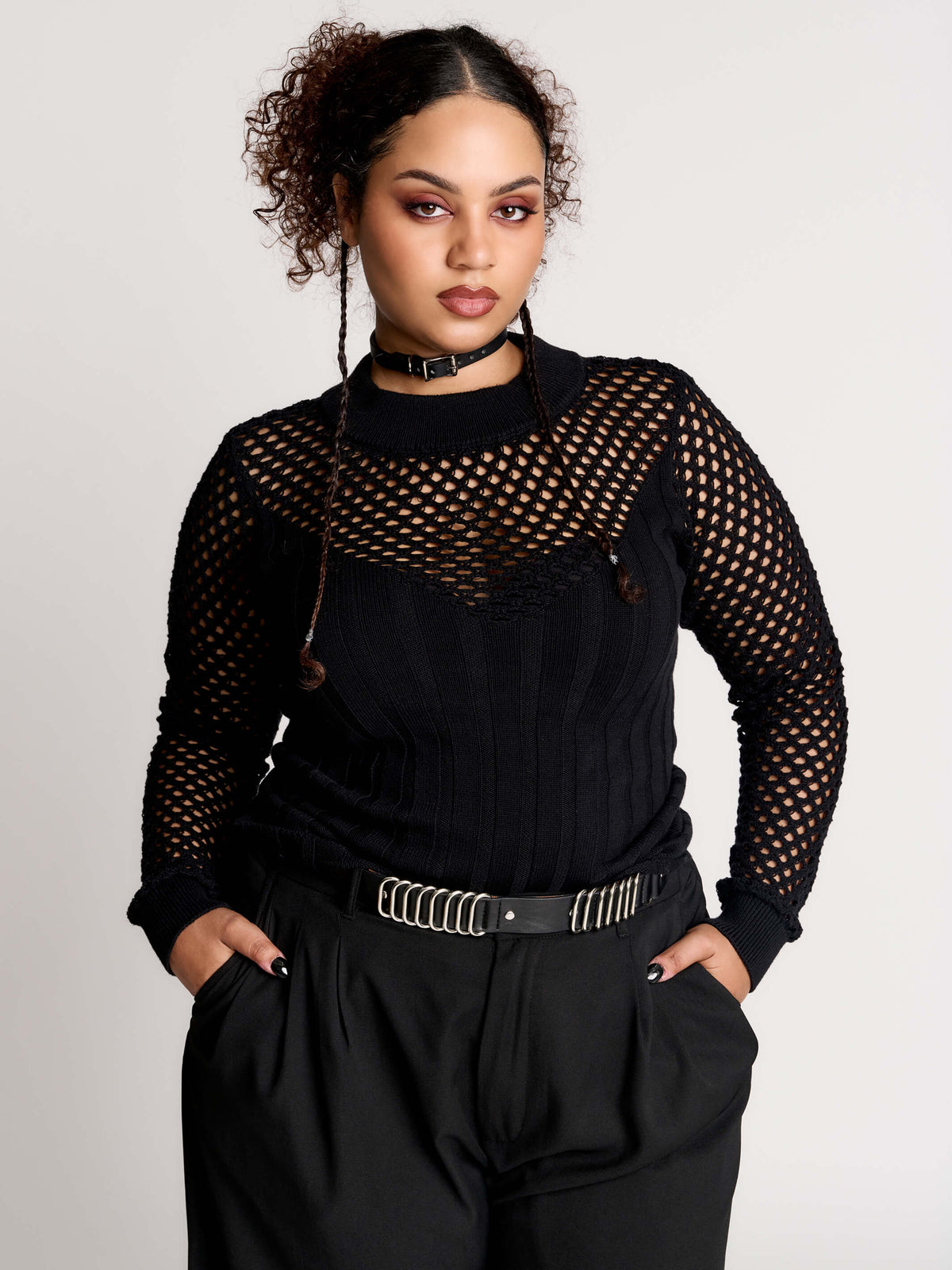 Fishnet Sweetheart Rib Sweater, a black long-sleeve top with a fitted rib-knit body and fishnet across the upper chest, shoulders, upper back and sleeves, giving a  “sweetheart” illusion while keeping the sleek silhouette sleek.
