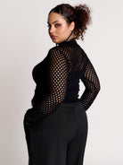 Fishnet Sweetheart Rib Sweater, a black long-sleeve top with a fitted rib-knit body and fishnet across the upper chest, shoulders, upper back and sleeves, giving a  “sweetheart” illusion while keeping the sleek silhouette sleek.