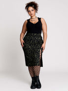 a black midi skirt with a green forest findings print. 