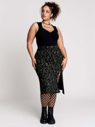 a black midi skirt with a green forest findings print. 