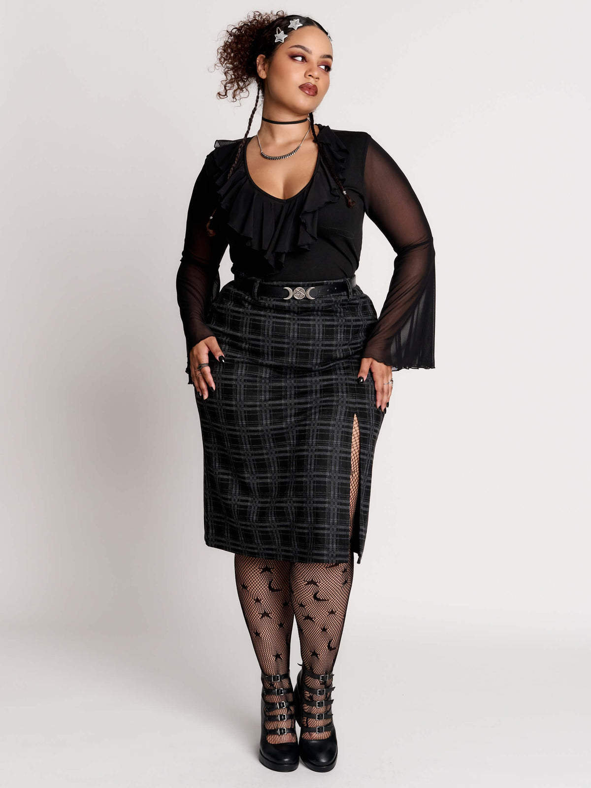  a black and gray plaid midi skirt with a front slit, 