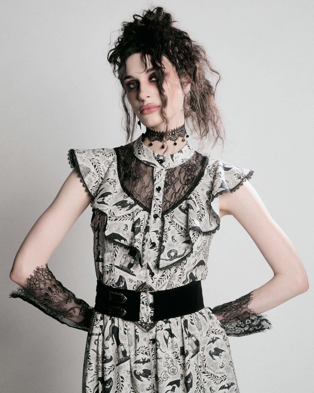 black and white gothic-style dress with a bird pattern, lace trim, and a high ruffled collar