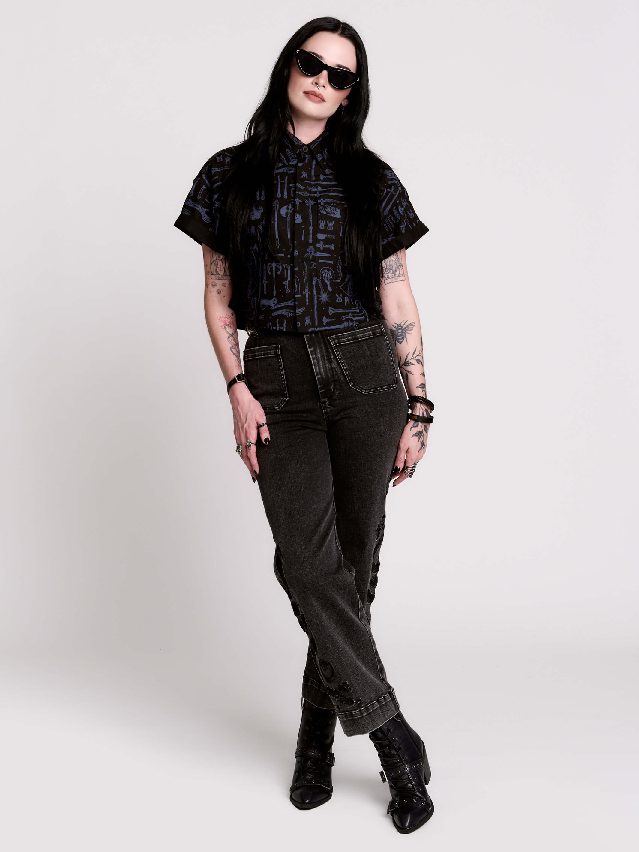 Armory Cropped Shirt is a boxy, cropped, short-sleeve button-down that mixes crisp classic shirting with dark, gothic illustration. 