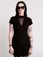 A black short-sleeve mock neck top with a fishnet mesh chest panel.