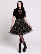 A  black flared skirt featuring a gray and purple gothic print with lace hem.