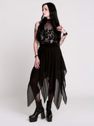 A black sleeveless top with a high mesh neck and an allover gothic-style print featuring silver snakes, moths, ravens and small pink floral accents.