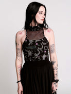 A black sleeveless top with a high mesh neck and an allover gothic-style print featuring silver snakes, moths, ravens and small pink floral accents.