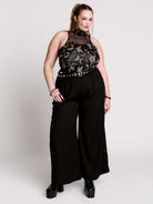 A black sleeveless top with a high mesh neck and an allover gothic-style print featuring silver snakes, moths, ravens and small pink floral accents.