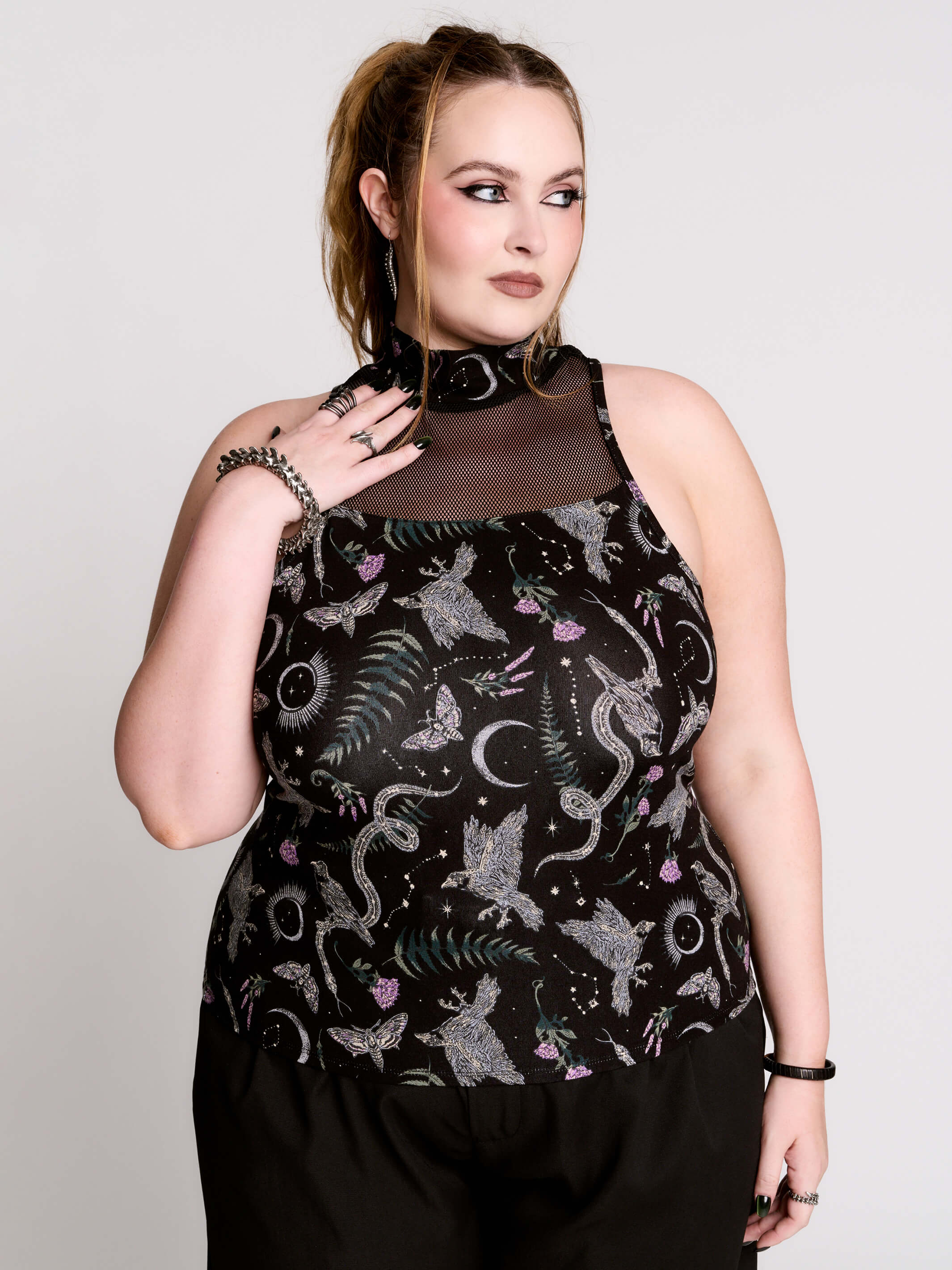 A black sleeveless top with a high mesh neck and an allover gothic-style print featuring silver snakes, moths, ravens and small pink floral accents.